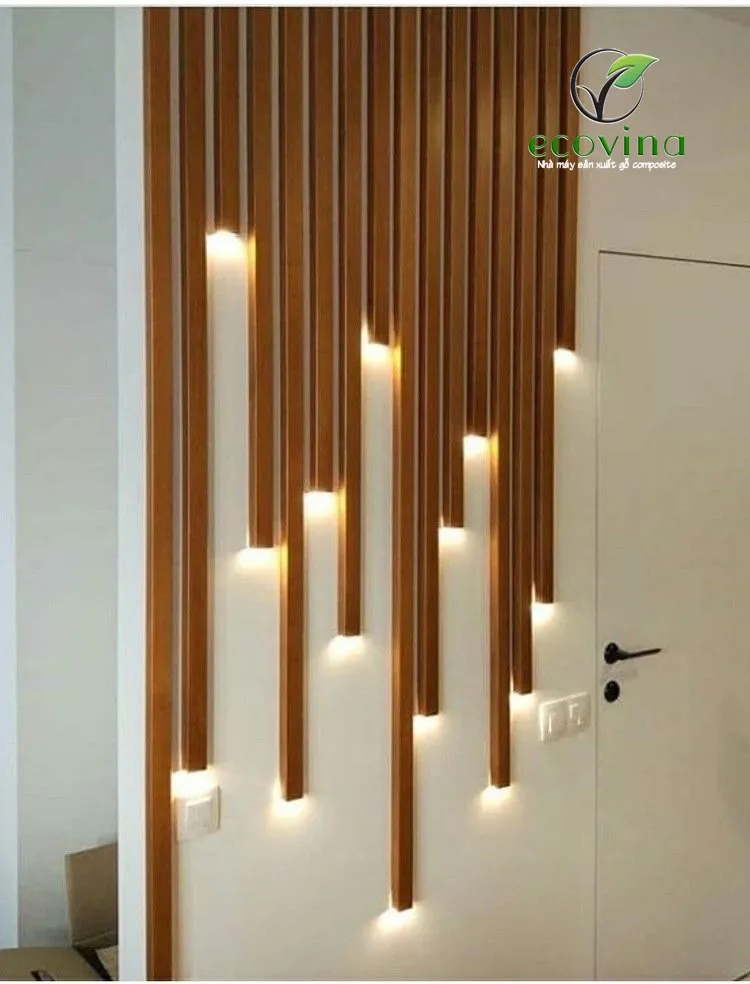 Không gian phòng khách được tô điểm bởi tấm composite ốp tường màu xám vân đá, tạo phong cách công nghiệp.