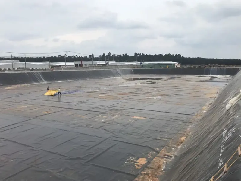 Kỹ sư đang chuẩn bị thiết bị kiểm tra khuyết tật bề mặt màng HDPE theo quy trình chuẩn