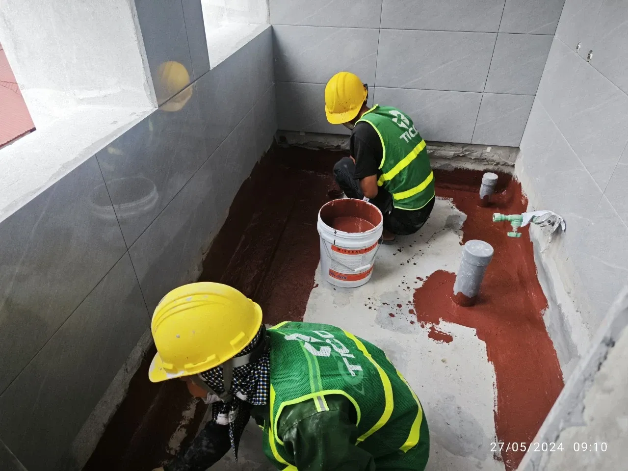 Kỹ sư và nhân công chống thấm thi công chi tiết cho khu vực cần bảo vệ