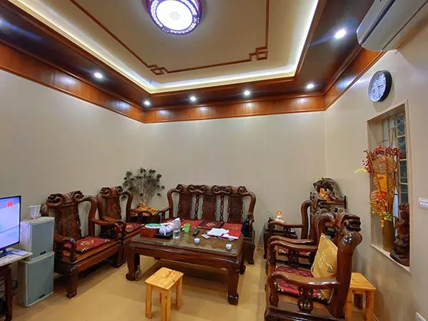 Phòng khách hiện đại với vách tivi ốp tấm nhựa giả gỗ sáng màu